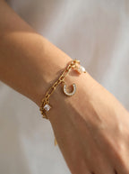 Aura Horseshoe & Pearl Charm Bracelet on white background